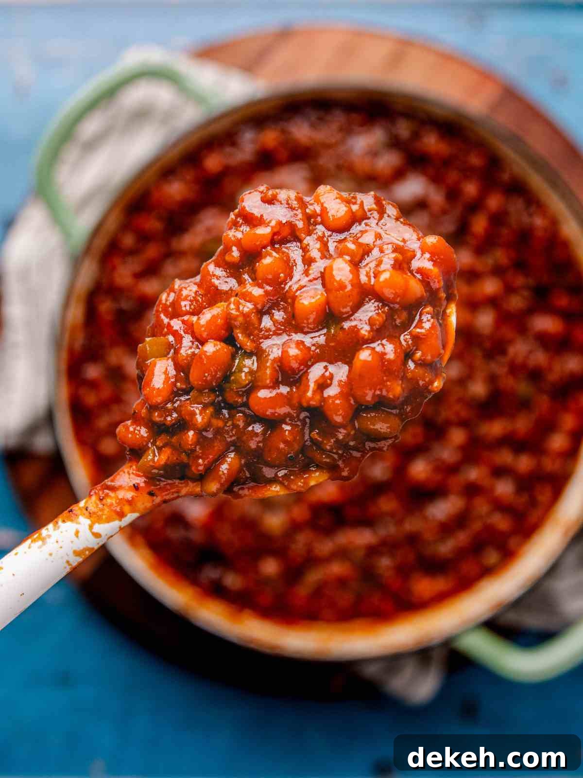 A scoop of baked beans in a spoon.