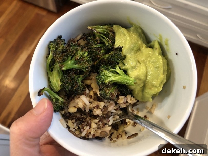 grain bowl with rice, lentils, roasted broccoli, and guacamole