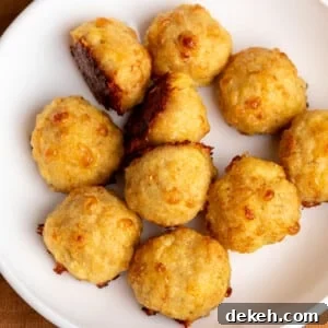 light tan baked chicken meatballs with dark brown spots in white bowl