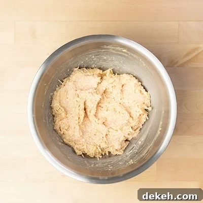 raw chicken meatball mixture in mixing bowl