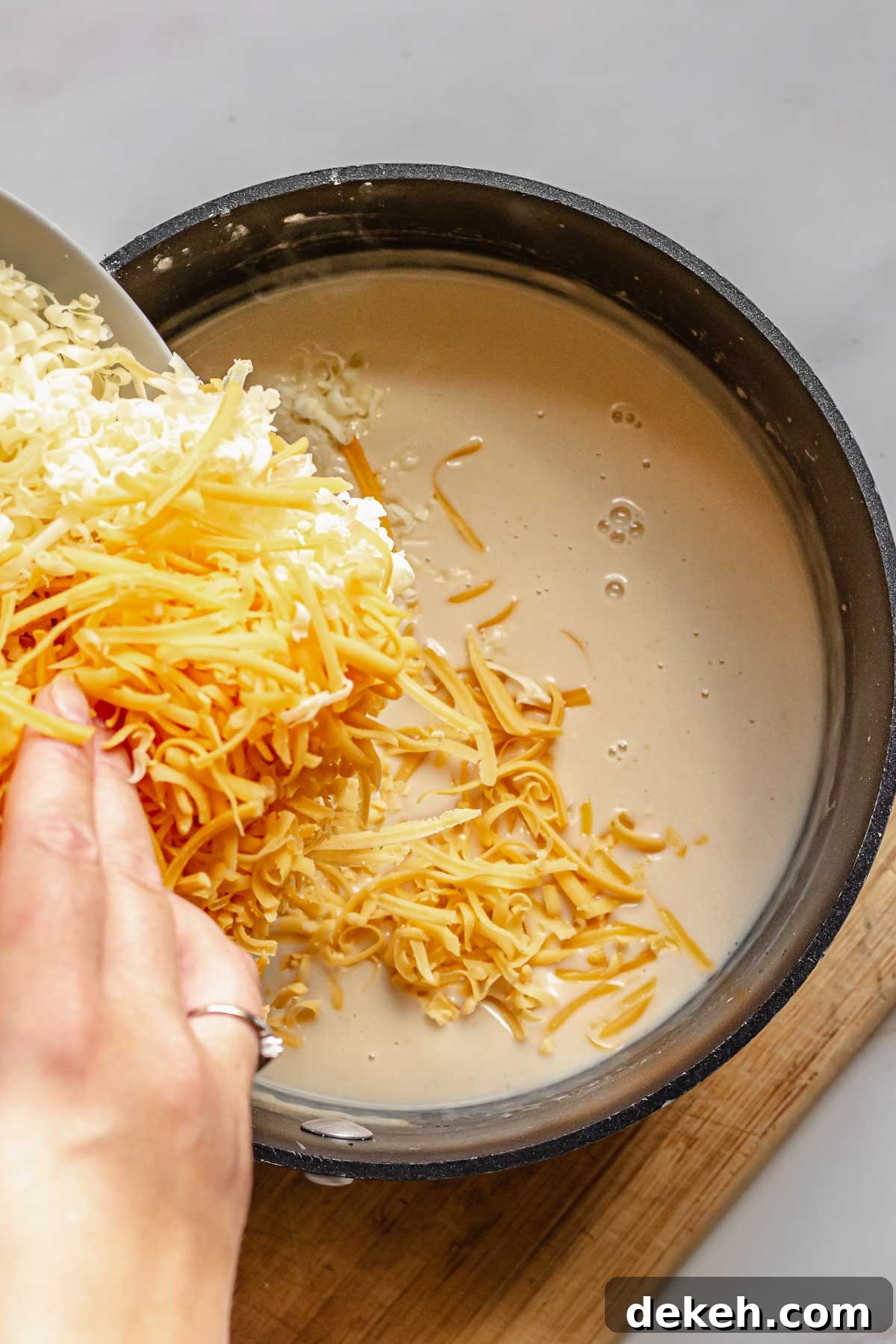 Cheese being added to the beer dip.