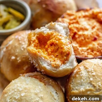 Mound of cheese filled pretzels with one broken in half.