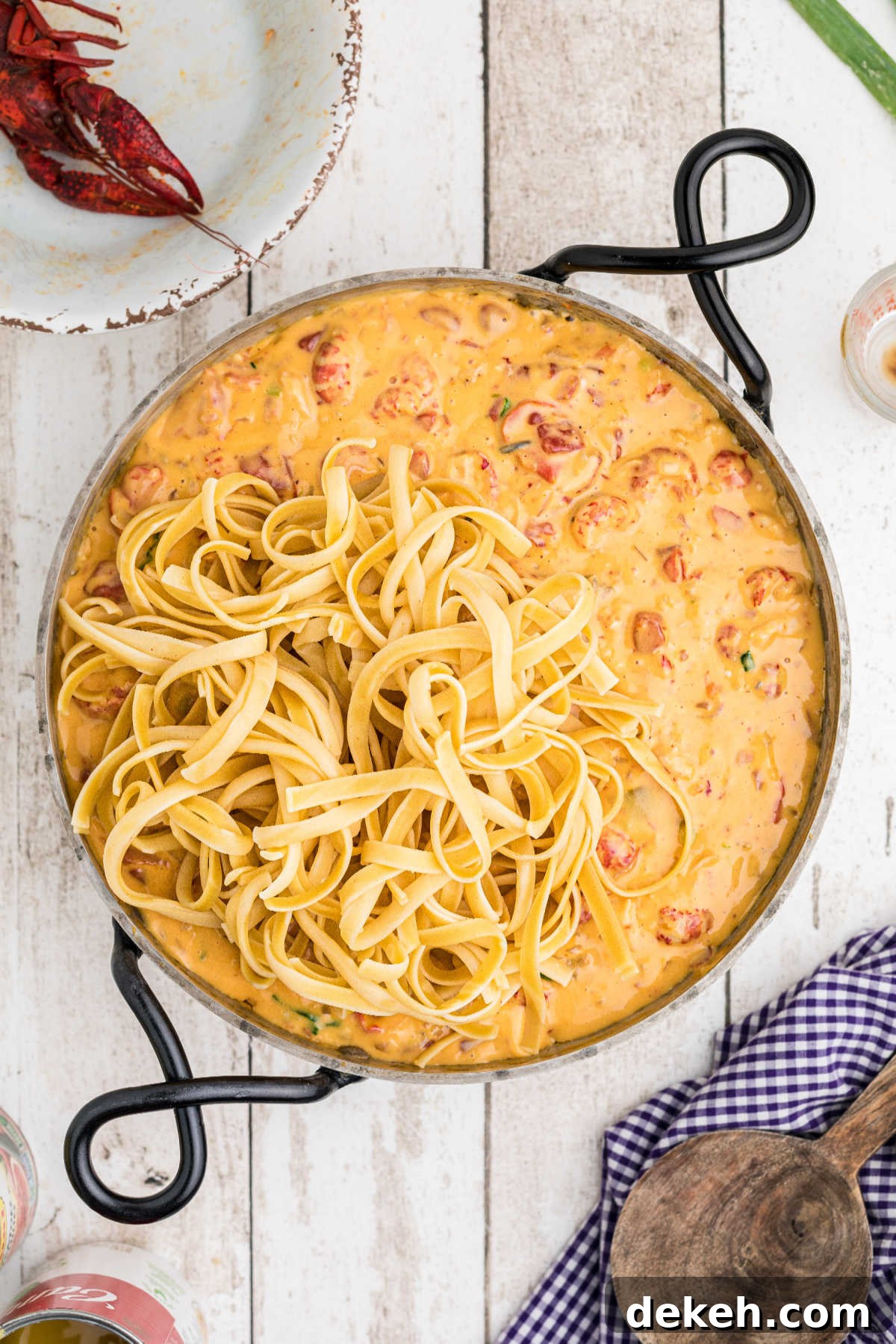 Cooked fettuccine added to a crawfish cheese sauce.