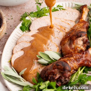 Turkey gravy from drippings is poured over sliced turkey breast for serving.
