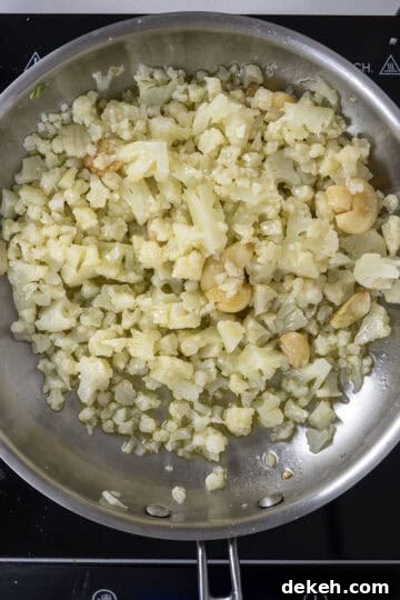 cauliflower added to saute pan with garlic.