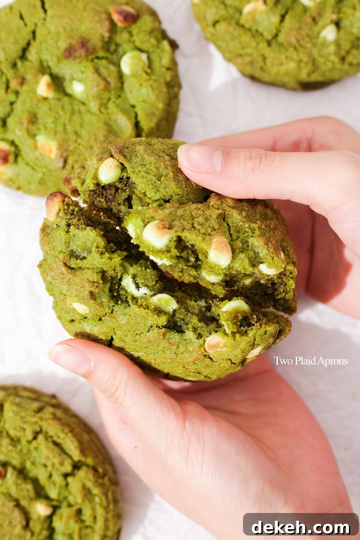 Breaking the matcha white chocolate cookie in half.