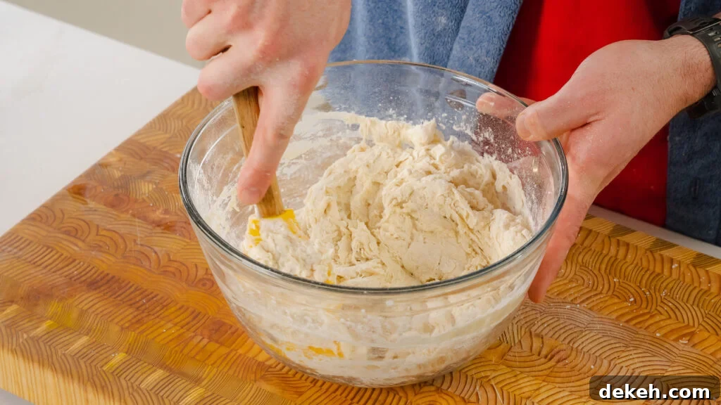 Mixing this no knead cheese bread dough in a large mixing bowl.