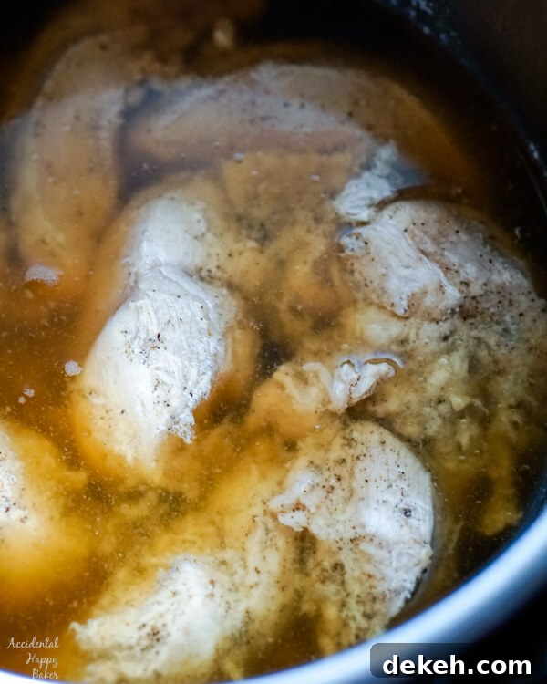 A image of the chicken in the instant pot after cooking.