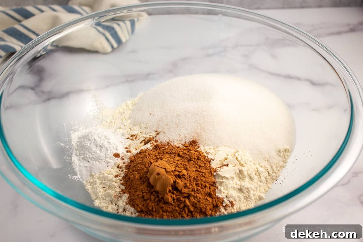 Dry cake ingredients in a glass bowl.