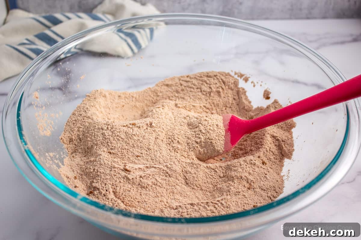 Flour, sugar and cocoa powder mixed together in a glass bowl.