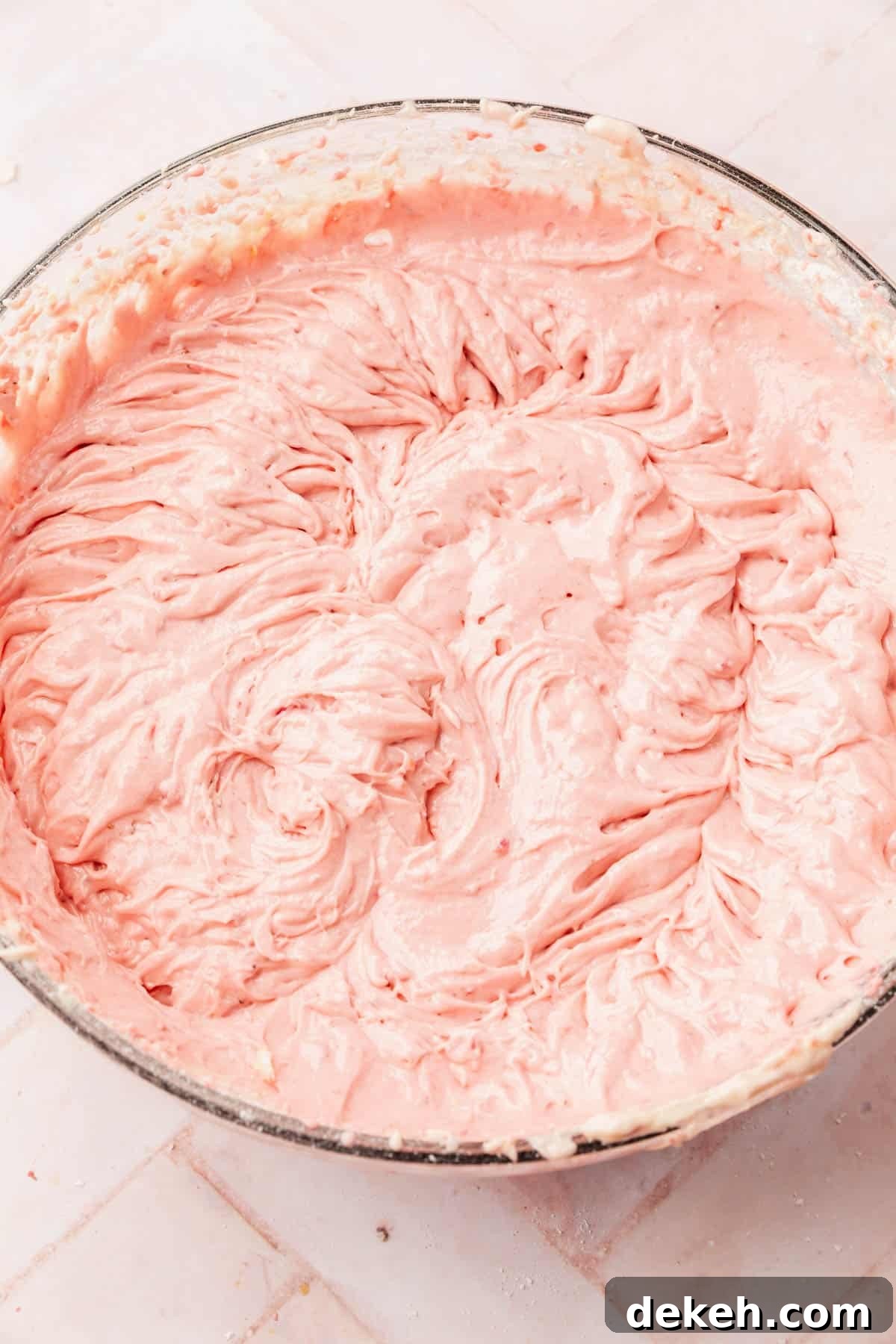 A large mixing bowl with gluten-free strawberry cake batter in it.