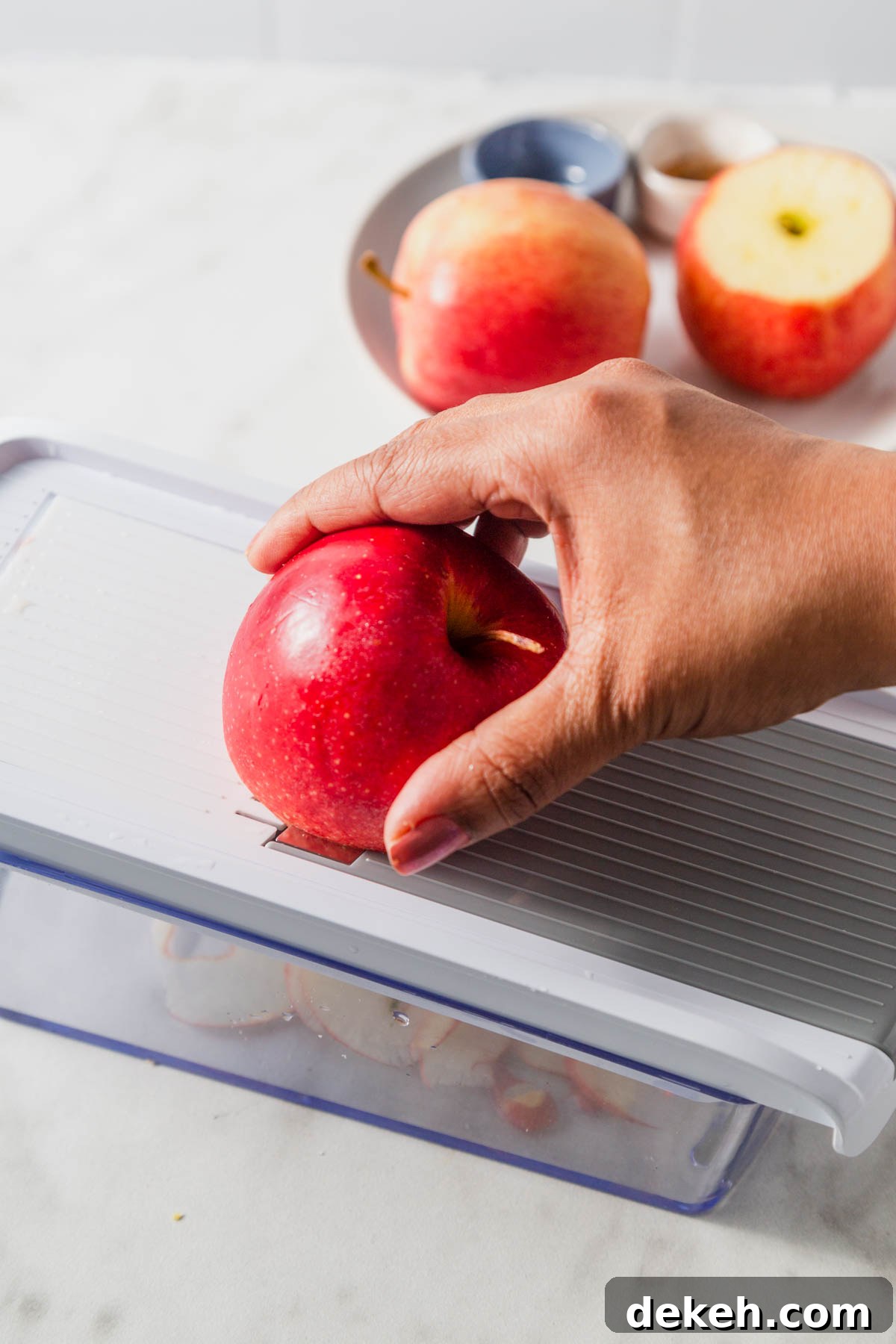 slicing apples in a mandoline slicer.