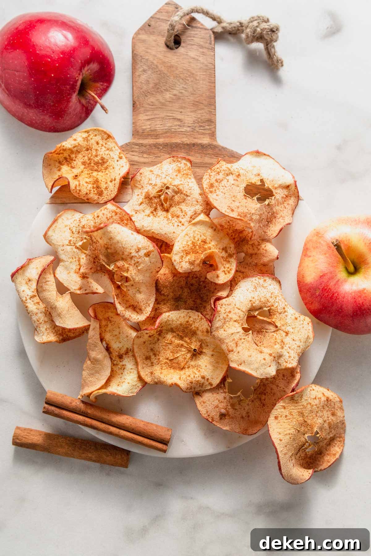 air fried apple chips on a board.