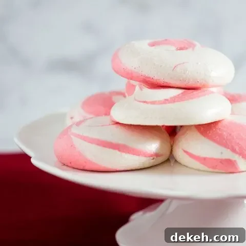 Beautiful swirled peppermint meringue cookies are a festive addition to your holiday party dessert tray! Bonus: they're naturally fat-free! #SundaySupper