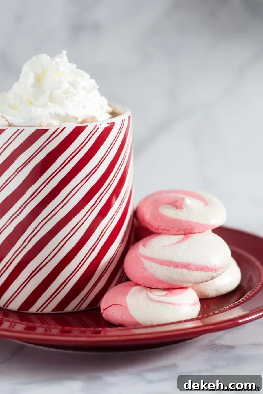 Beautiful swirled peppermint meringue cookies are a festive addition to your holiday party dessert tray! Bonus: they're naturally fat-free! #SundaySupper