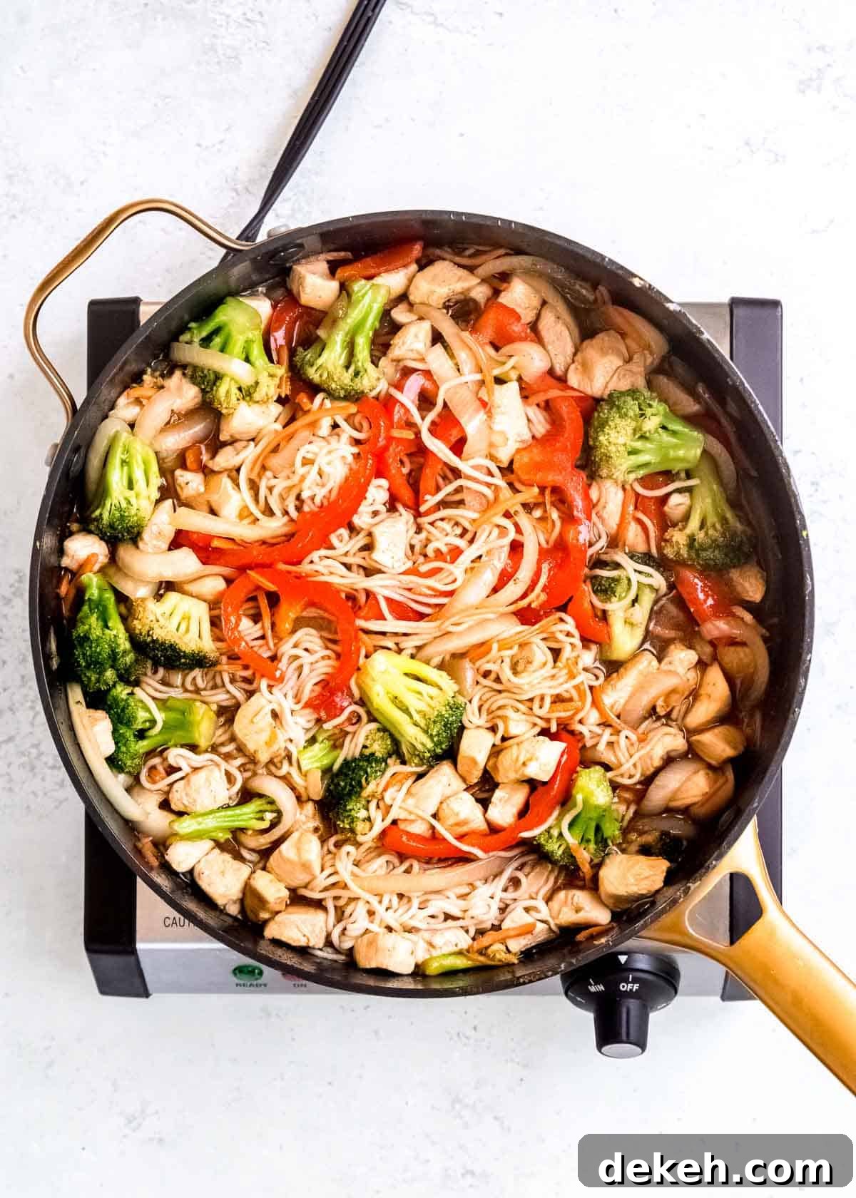 stir fry sauce stirred into the shirataki noodles, chicken, and sauteed vegetables