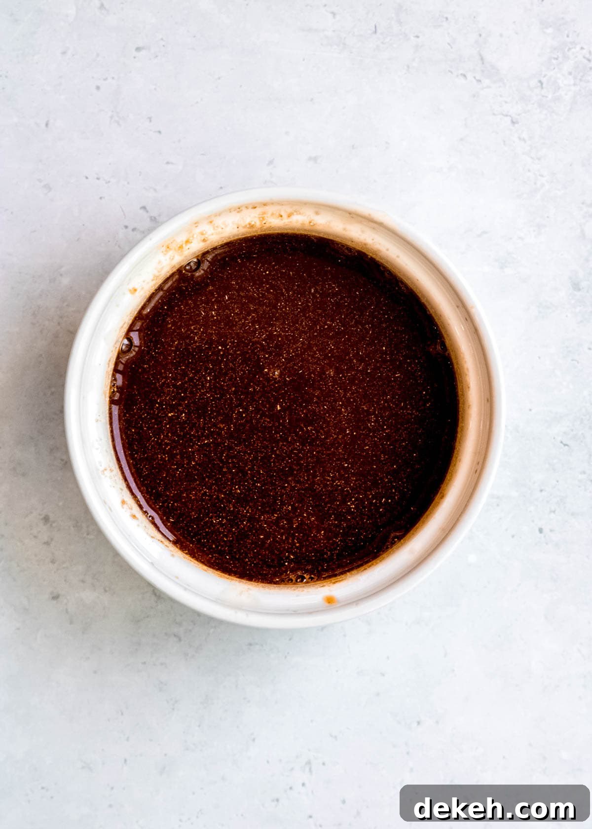 ingredients for stir fry sauce in a white ramekin on a white background