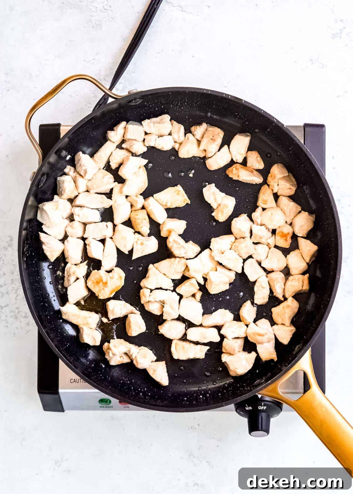 chicken bites searing in a skillet