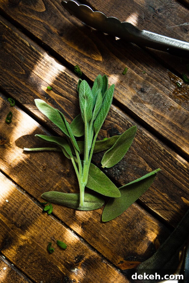 a photo of a bundle of fresh sage leaves sitting on a wooden table