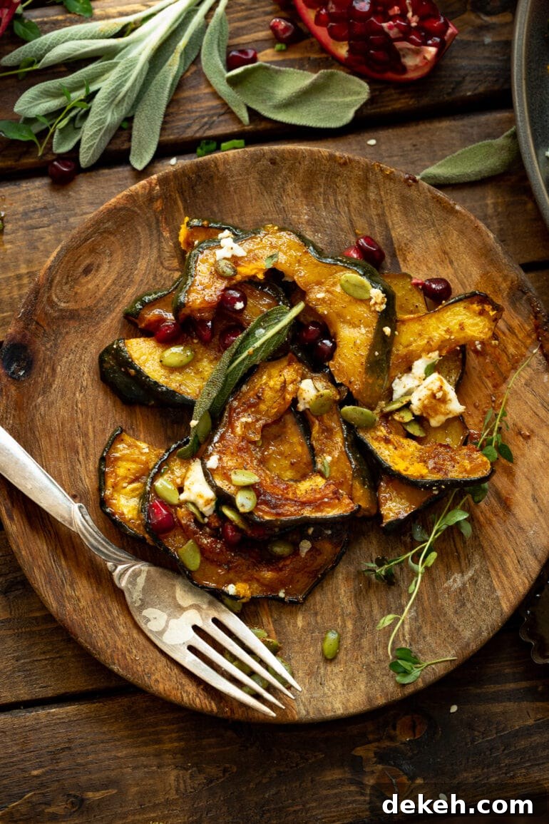 a photo of a serving of holiday acorn squash on a wooden plate with a silver fork sitting next to it