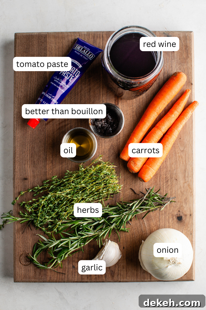 tube of tomato paste, mason jar of red wine, pinch bowls of oil and better than bouillon, 3 whole carrots, fresh rosemary and thyme, garlic and a whole onion on a butchers block.