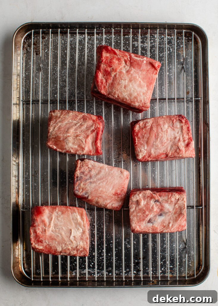 seasoned short ribs on a pan with with wire rack