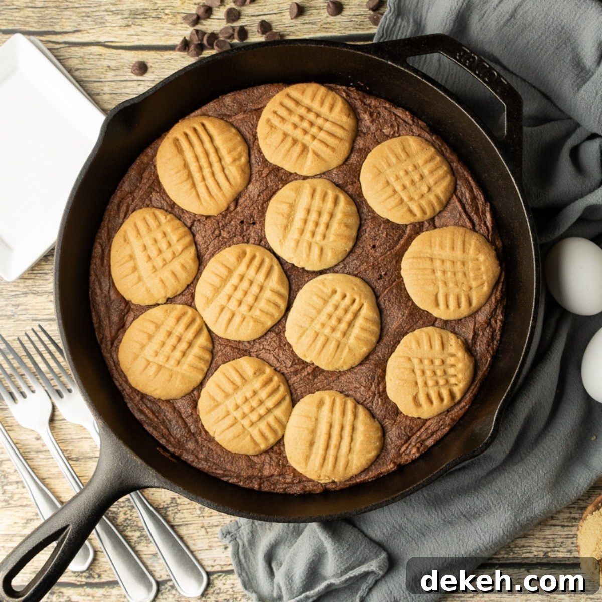 peanut butter cookie topped brownie in a cast iron skillet