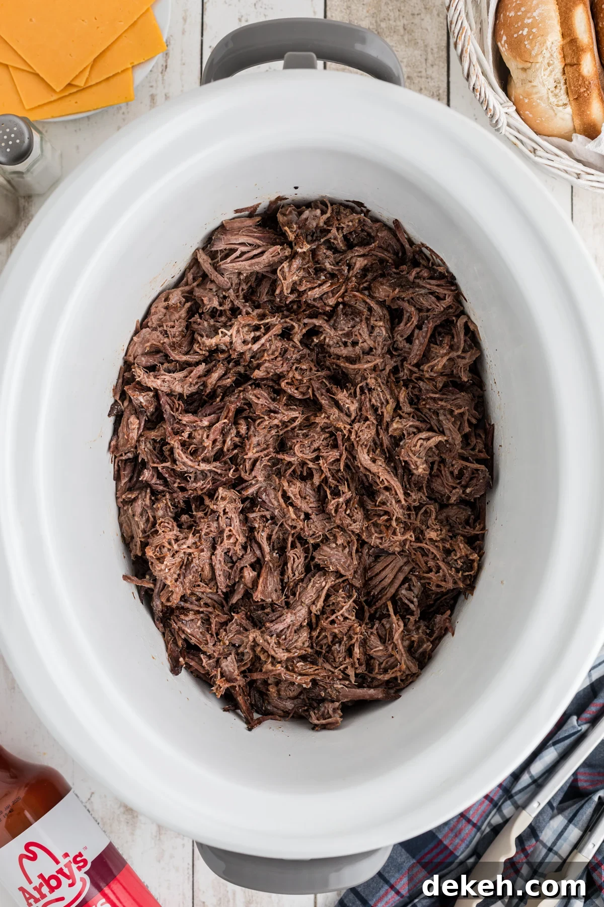 shredded meat in a crockpot for slow cooker arby's beef and cheddars.