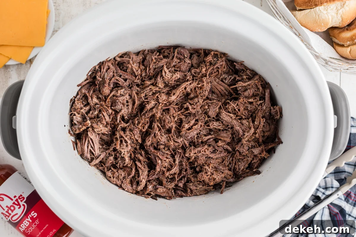 overhead of cooked meat for slow cooker arby's beef and cheddars.