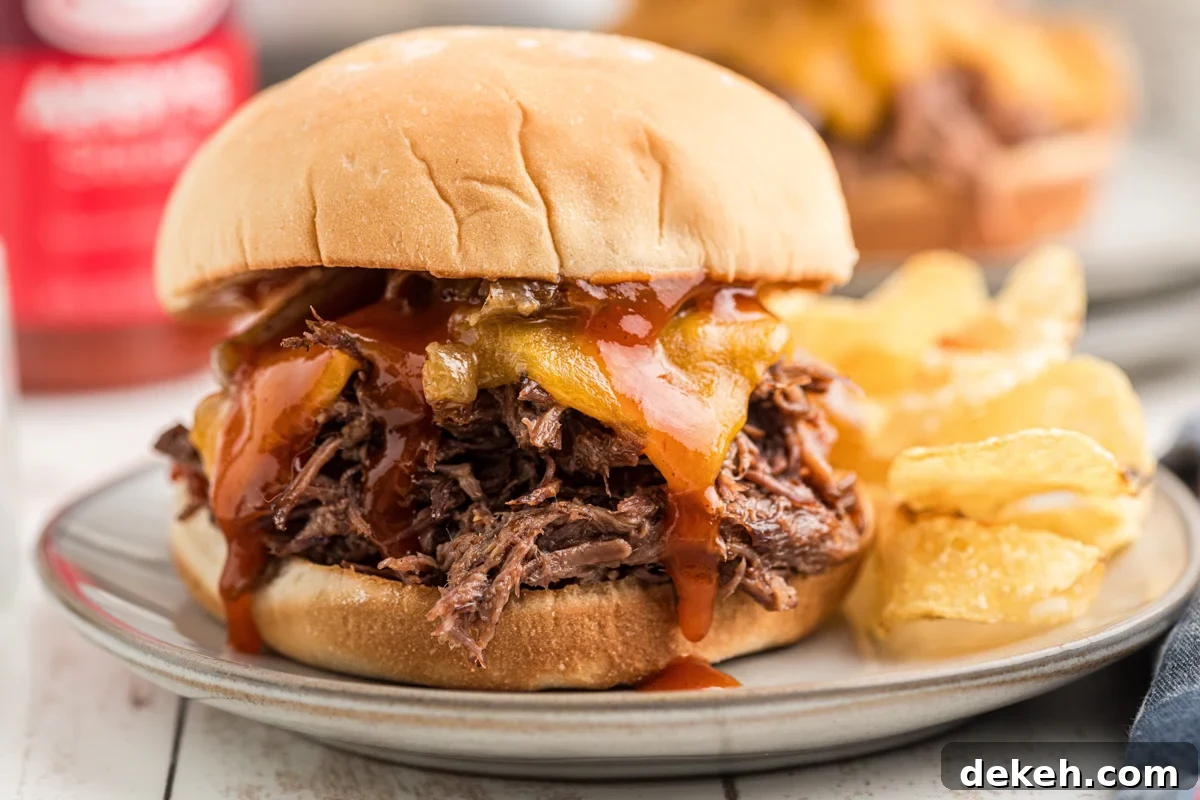 close-up of one of the slow cooker arby's beef and cheddars on a plate.