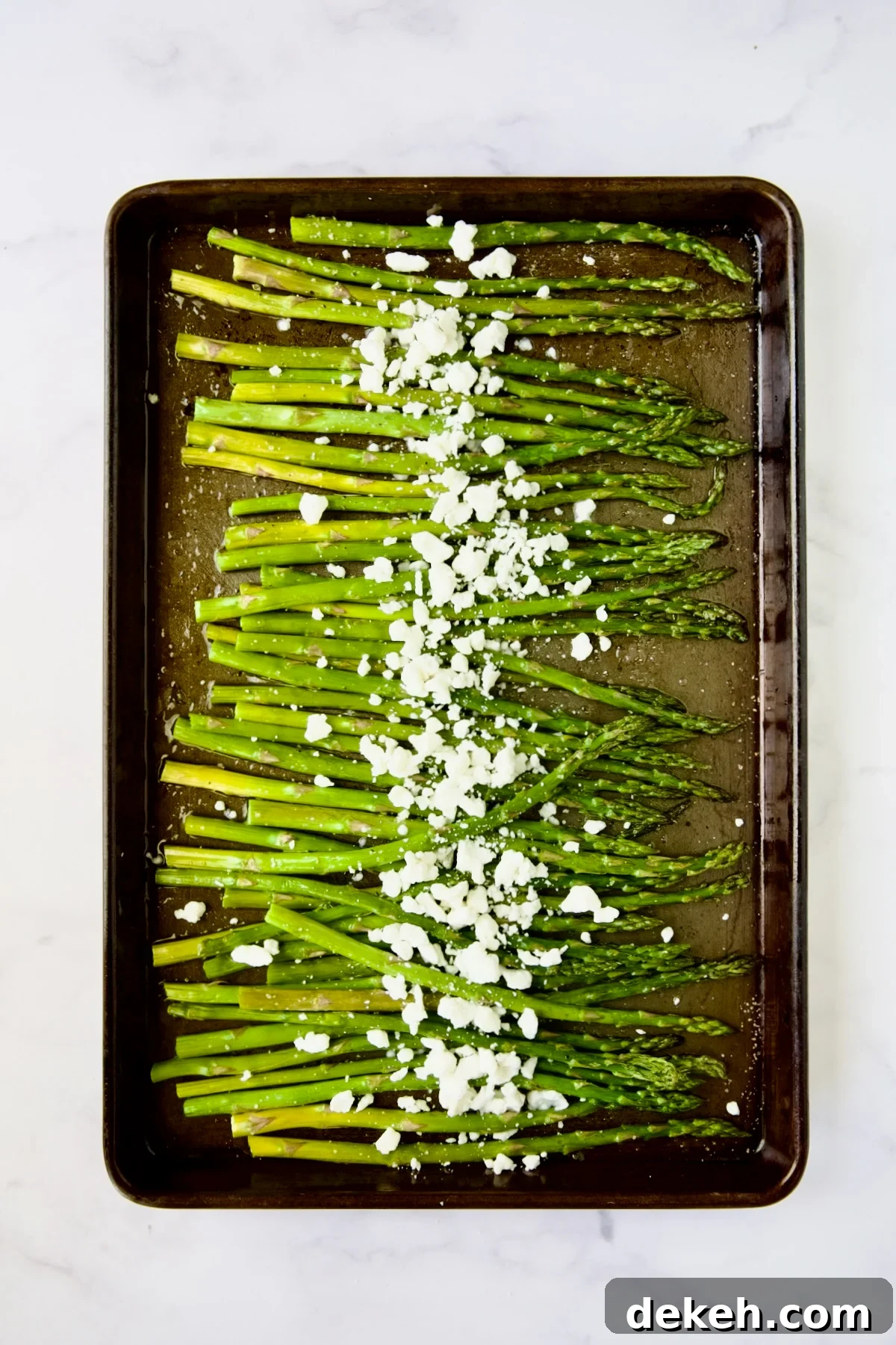 Roasted asparagus sprinkled with goat cheese.