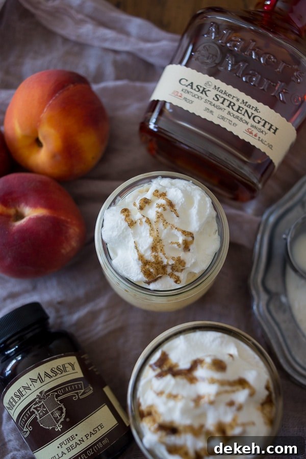This vanilla peach bourbon milkshake is the perfect boozy summertime frozen treat. Vanilla bean paste mixed with fresh peaches, bourbon and vanilla bean ice cream. It's the perfect cocktail + dessert!