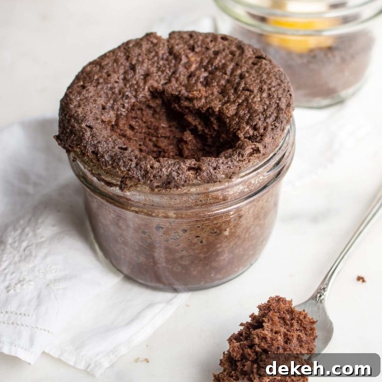 chocolate peanut butter mug cake in a mason jar with a bite missing