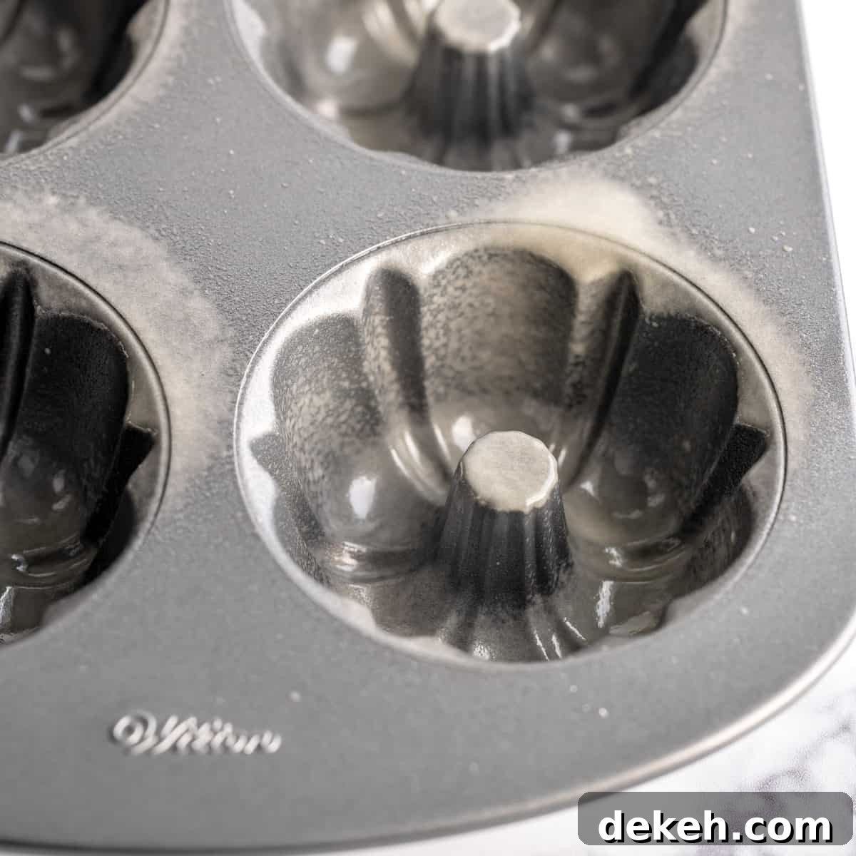 A mini bundt pan sprayed with cooking spray