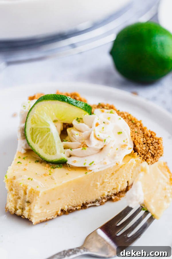 Simply Amazing Key Lime Pie Key lime pie close-up with whipped cream and lime twists