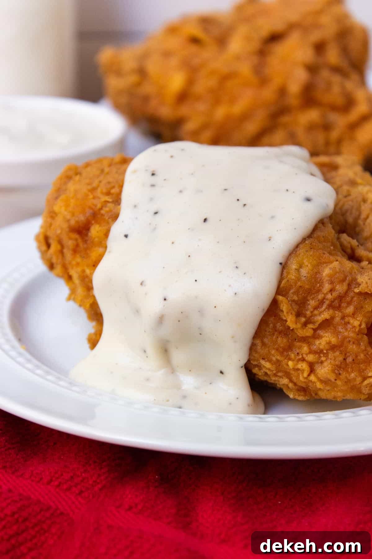 Southern Country Gravy Recipe for Biscuits and Breakfast Plates 2 Southern Country Gravy over fried chicken