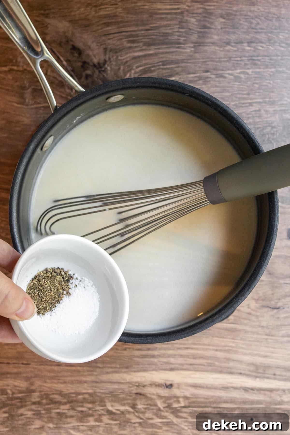 Southern Country Gravy Recipe for Biscuits and Breakfast Plates 7 Adding salt and pepper to white gravy mixture.