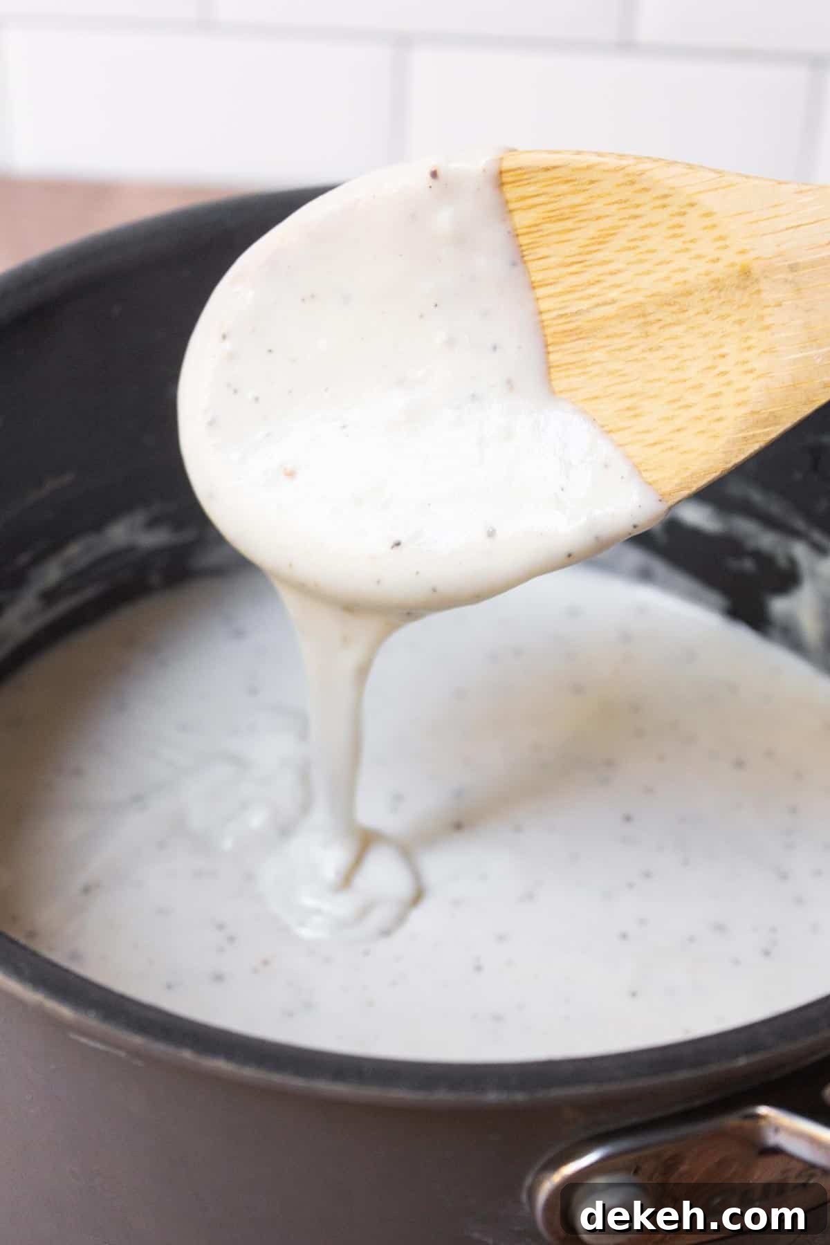 Southern Country Gravy Recipe for Biscuits and Breakfast Plates 8 Thick southern country gravy dripping from a spoon