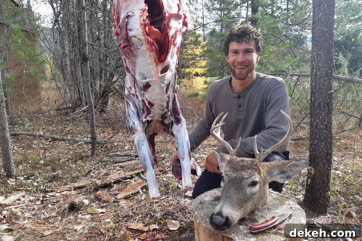 Is Hunting for Game Cheaper Than Buying Meat? 3 A man with a deer hanging in a tree and a buck's head on the ground nearby.