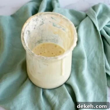 A jar of sourdough discard on a kitchen towel.