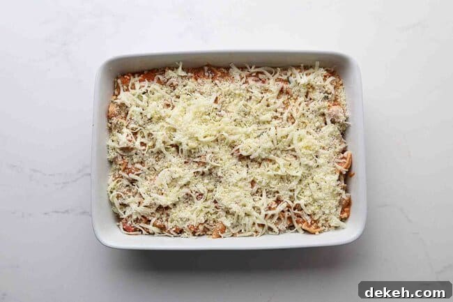 Pasta topped with cheese in a baking dish.