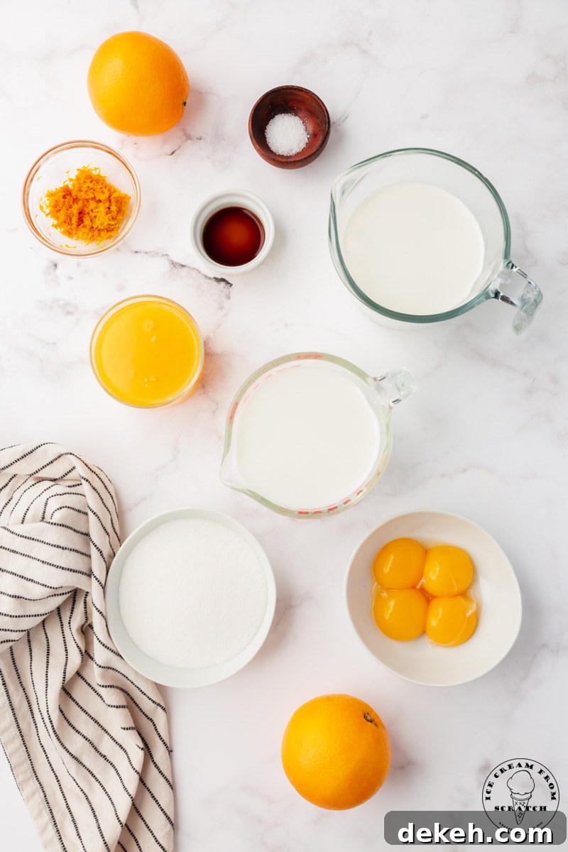 The ingredients needed to make orange ice cream from scratch, viewed from above