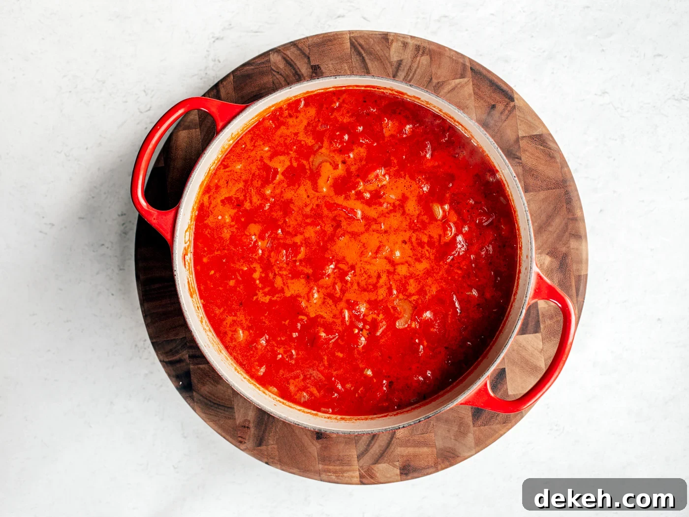 Creamy Homemade Tomato Soup Recipe with Basil and Garlic 4 Dutch oven full of tomato soup prior to being blendy, full of chunky tomatoes and veggies.
