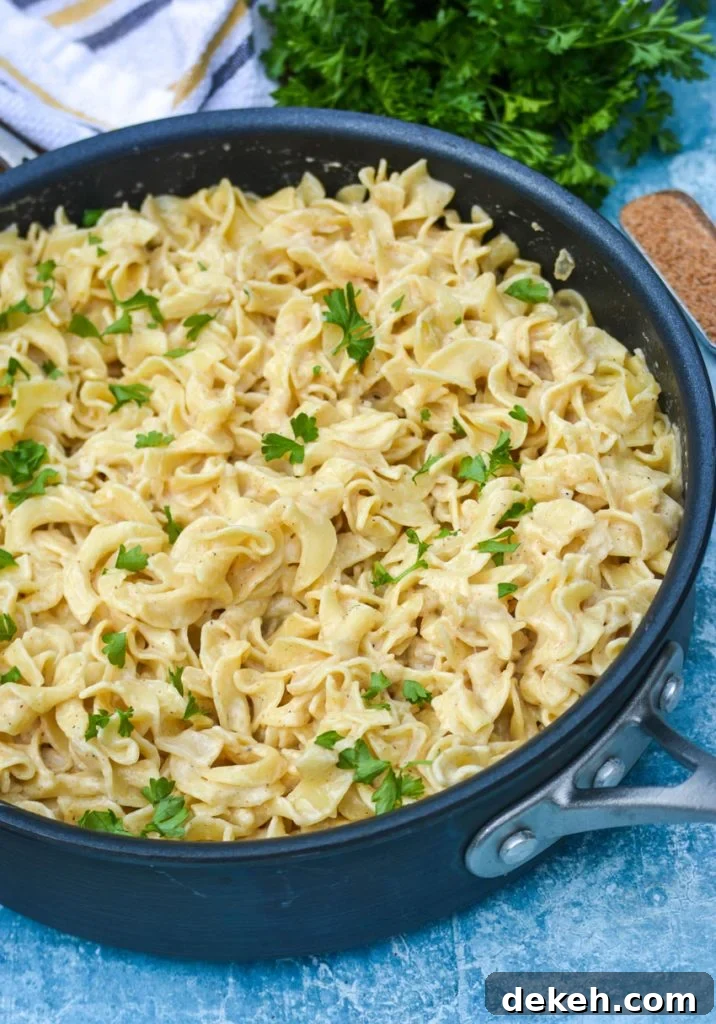 Creamy Cajun Egg Noodles Recipe with Spicy Sausage and Veggies 3 Egg noodles in skillet