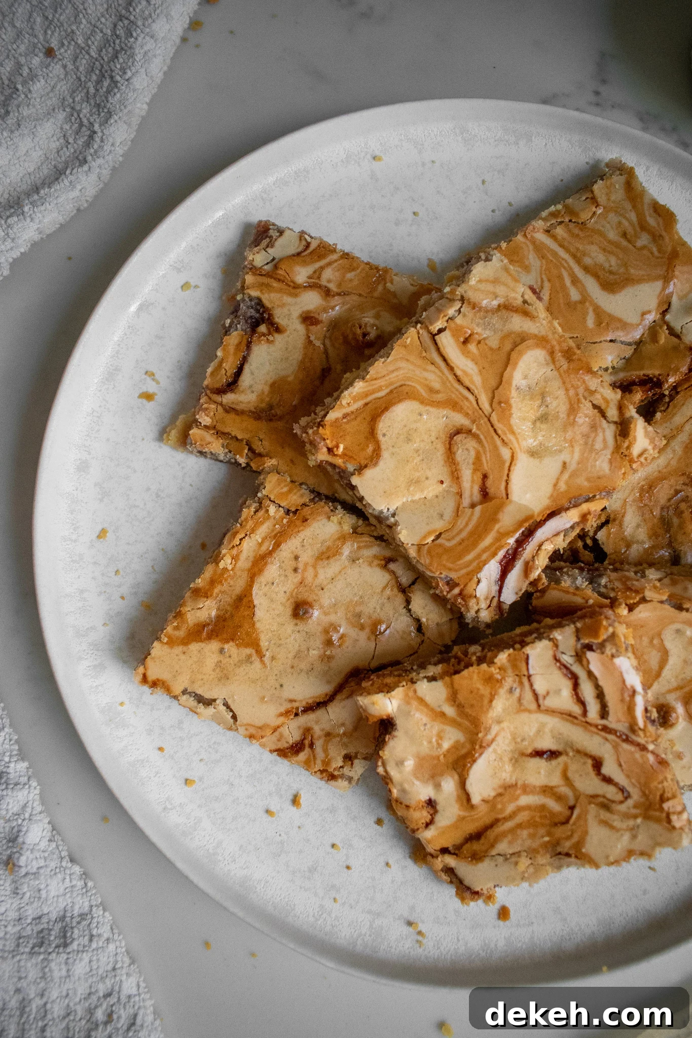 Almond and jam slices in a stack.