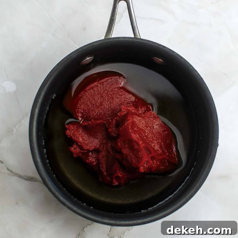 Homemade Tomato Ketchup Recipe from Scratch 5 Overhead view of process shot 2 - add the tomato paste and stir until mixed.