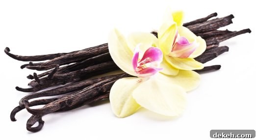 Insider Baking Techniques from a Pastry Chef 3 A bundle of whole vanilla beans with 2 vanilla orchid flowers.
