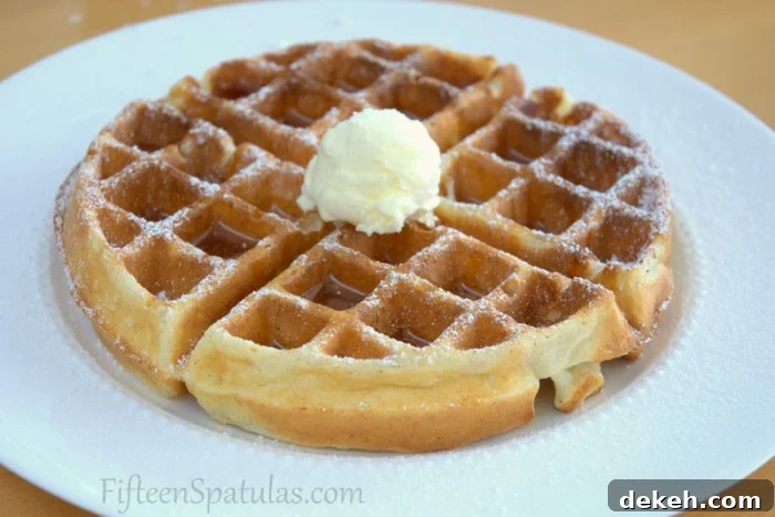 Super crispy waffles recipe Crispy Whole Waffle on Plate with Butter, Maple Syrup, and Powdered Sugar