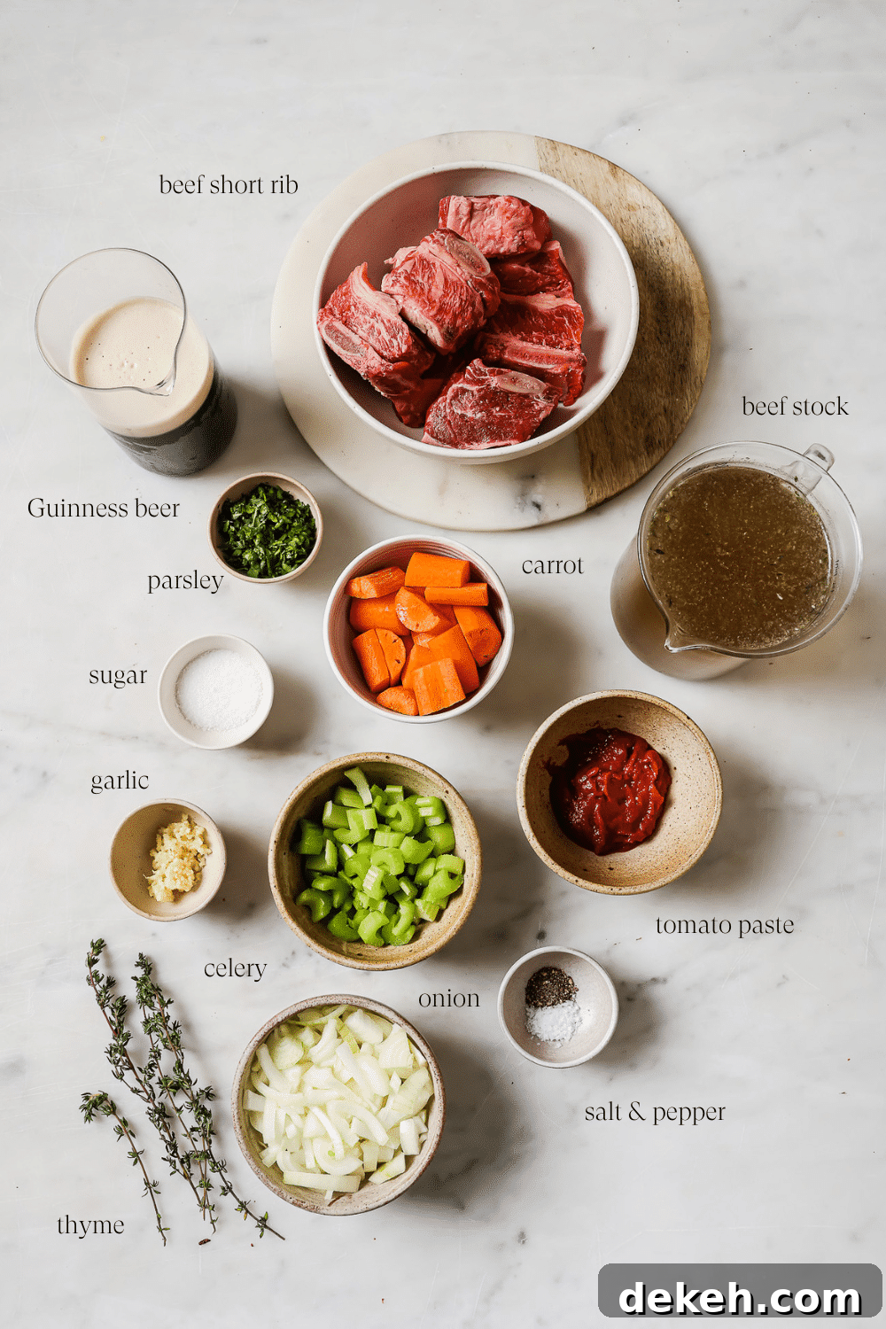Tender Guinness-Braised Short Ribs 3 All the ingredients to make the Guinness Short Ribs on a white marble countertop.