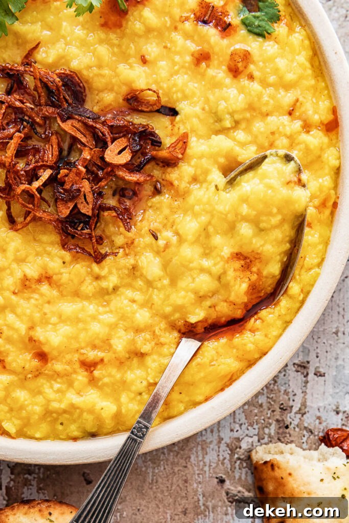 Restaurant-Style Moong Dal Tadka Recipe 3 Close up of bowl of the curry with a spoon